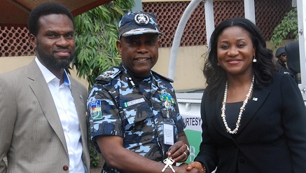 Mrs. Mary Akpobome, Executive Director, Heritage Bank, (r) presenting Hilux Van key to Mr. Kayode Aderanti, Commissioner of Police, Lagos State, and Mr. Fela Ibidapo, Head, Corporate Affair Heritage Bank, looks on, during the Bank’s donation of Patrol vehicles and other  security gadgets to the Police Command in Lagos State .